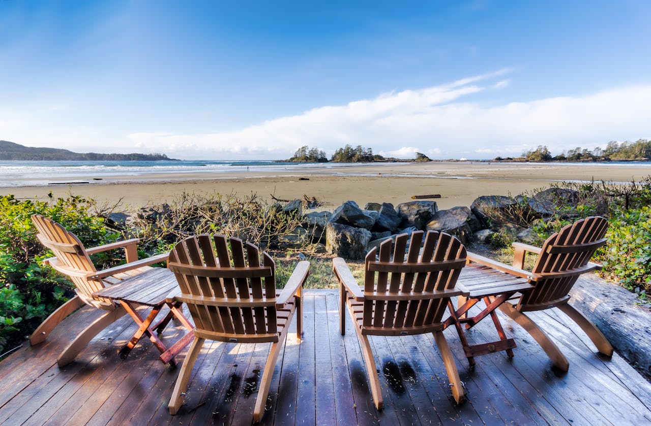 Four Brown Adirondack Chairs On Porch